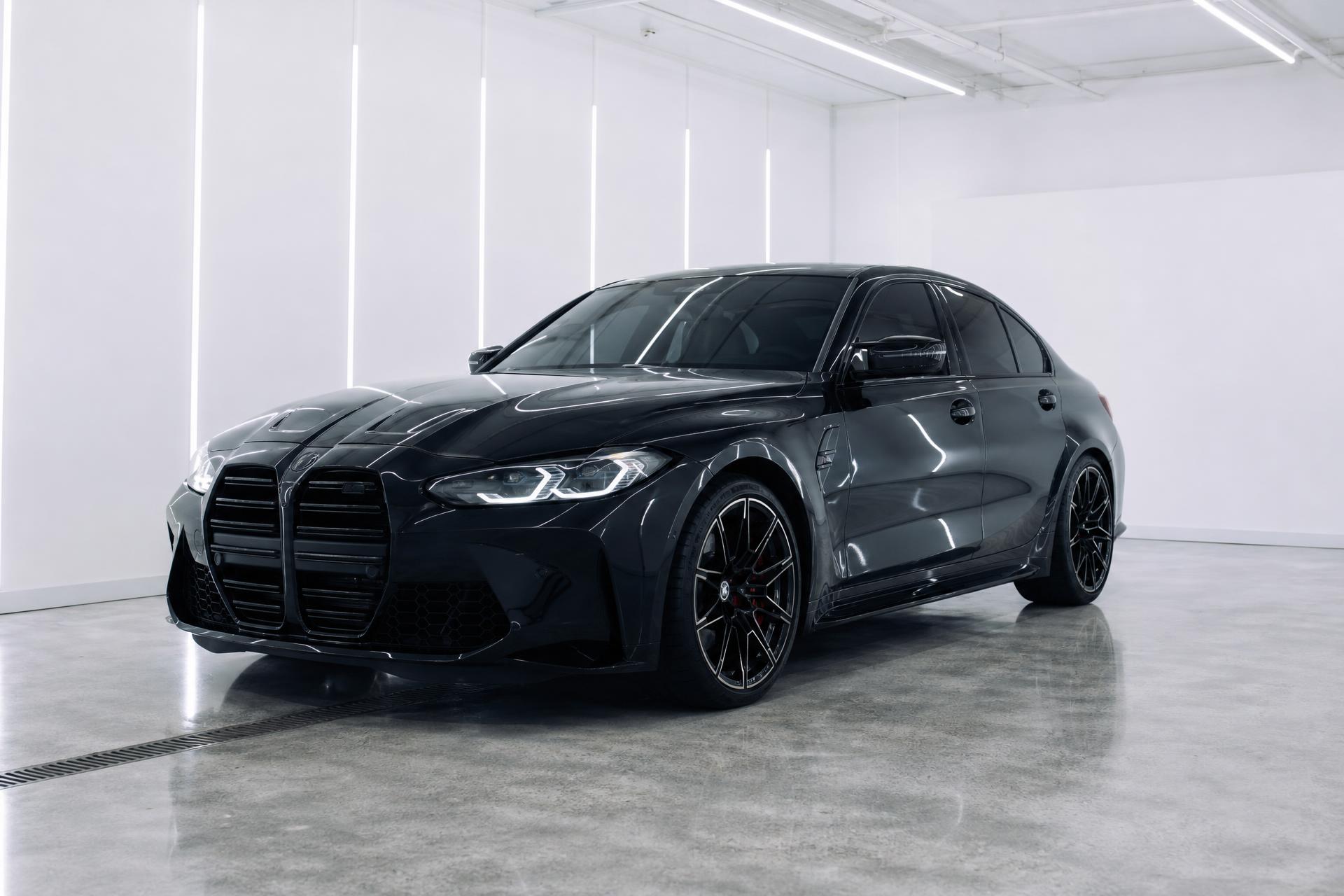 A freshly ceramic coated luxury sedan with deep gloss paint reflecting studio light